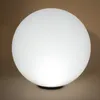 A white spherical lamp on a brown background. Produktbild-Vorschau