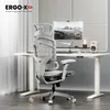 An ergonomic office chair is shown in a modern office setting with a desk, computer, and speaker. Voir les images du produit