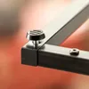 A close-up view of a black metal table leg with a screw-in rubber foot. Voir les images du produit