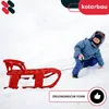 A child is pulling a red sled through the snow. Voir les images du produit