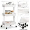 A white three-tier rolling cart with various items on its shelves, shown with close-up insets highlighting features. Voir les images du produit