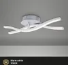 A modern LED ceiling light with a silver base and two curved white light elements, shown against a light gray ceiling. Produktbild-Vorschau