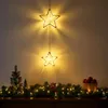 Christmas decorations on a shelf, including lit star ornaments, a garland, and a basket of ornaments. Voir les images du produit