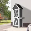 A garden shed is shown on a patio next to a wall, with a hanging chair and greenery in the background. Anteprima dell’immagine prodotto