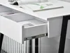 Close-up of an open drawer in a white desk with black legs. Anteprima dell’immagine prodotto