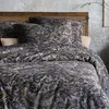 A close-up view of a bed with paisley-patterned bedding. Produktbild-Vorschau