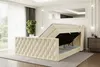 A bedroom scene featuring a beige velvet boxspring bed with its storage compartment open, revealing the mattress and topper. Produktbild-Vorschau