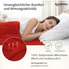 A woman sleeping on a bed with red bedding. Produktbild-Vorschau