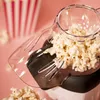 A close-up of a popcorn machine with freshly popped popcorn. Podgląd zdjęcia produktu