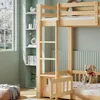 A wooden bunk bed with a ladder and a small gate, set in a child's room with shelves and a window. Podgląd zdjęcia produktu
