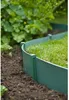 A close-up shot of green garden edging separating a lawn from a dirt path, with lush green foliage in the background. Produktbild-Vorschau