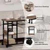 A side table with storage shelves next to a couch. Produktbild-Vorschau