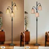 A split image showing a floor lamp in two states: on and off, in a living room setting. Náhľad obrázku produktu