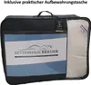 A black storage bag containing a folded duvet or comforter, with branding and text visible on the front. Produktbild-Vorschau