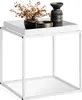 A white metal side table with decorative items on top. Produktbild-Vorschau