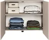 An open cabinet with two shelves, displaying folded clothes and storage boxes. Anteprima dell’immagine prodotto