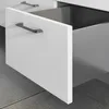 A close-up view of a white drawer with a silver handle, partially open to reveal the inside of a cabinet. Produktbild-Vorschau