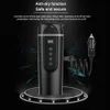 A black electric kettle with a car charger connector, displayed on a podium with lights. The background is dark with a starry or cosmic effect. Podgląd zdjęcia produktu