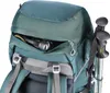 Close-up view of a green rucksack with a flashlight in an outer pocket and trekking poles attached to the side. Produktbild-Vorschau