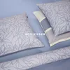 A close-up view of bedding with a floral pattern, including pillows and a bolster. Produktbild-Vorschau