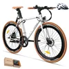 A white electric bicycle with tan accents is shown against a white background. A white helmet is placed to the upper right of the bicycle. A small gift box is in the lower left corner. Produktbild-Vorschau