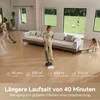Two women are cleaning a modern living room with a cordless wet and dry vacuum cleaner. The background shows a large window with a view of a green lawn and a child playing with a dog. Voir les images du produit