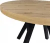 A close-up view of a round table with a wood-grain top and black legs. Náhled obrázku produktu
