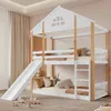 A children's bunk bed with a slide and ladder, set up in a bedroom with curtains and toys. Produktbild-Vorschau