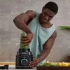 A man is using a Ninja blender to make a smoothie. Produktbild-Vorschau