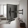A television mounted on a wall with a wall mount, in a modern living room. Podgląd zdjęcia produktu