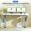 A white height-adjustable desk with dual monitors, set up in a home office environment. Voir les images du produit