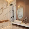 A modern bathroom with a marble shower and vanity, featuring a unique mirror and sink. Produktbild-Vorschau