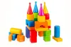 A collection of colorful building blocks arranged in a castle-like structure, with some loose blocks in the foreground. Podgląd zdjęcia produktu