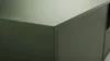 A close-up view of the corner of a green TV cabinet. Náhled obrázku produktu