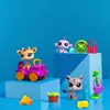 A collection of Littlest Pet Shop safari-themed toys arranged on blue blocks against a blue background. Náhľad obrázku produktu