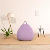 A single purple beanbag chair is placed on a rug in a minimalist room with a floor lamp and a small side table. Anteprima dell’immagine prodotto