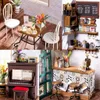 A collage of miniature scenes depicting a cafe and a room with a piano. Anteprima dell’immagine prodotto
