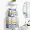 A towel rack with towels and a plant in a bathroom setting. Produktbild-Vorschau