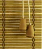 A close-up view of bamboo blinds with wooden pull cords. Produktbild-Vorschau