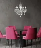 A dining set with a chandelier in a room with a dark gray wall and wooden floor. Anteprima dell’immagine prodotto