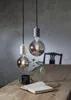 Two decorative LED light bulbs hanging over a wooden table with a book and a mug. Podgląd zdjęcia produktu