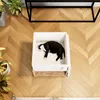 A black and white cat is sleeping in a white pet bed on a wooden floor. Produktbild-Vorschau