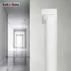 A white ventilation pipe connector is mounted on a textured light gray wall, with a blurred hallway in the background. Anteprima dell’immagine prodotto