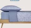 A close-up view of a bed with a pillow and duvet cover, showcasing a leaf pattern. Produktbild-Vorschau