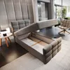 A modern bedroom with a grey upholstered bed frame open to reveal storage space. Produktbild-Vorschau