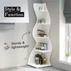 A white wavy corner shelf filled with various items, placed against a light gray wall next to a window. Podgląd zdjęcia produktu