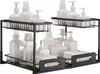 Two black, two-tiered under-sink organizers filled with various bottles and folded towels. Náhled obrázku produktu