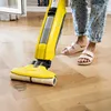 A person is using a yellow Kärcher floor cleaner on a wooden floor. Anteprima dell’immagine prodotto