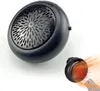 A black mini heater is shown on a white background, with a smaller version of the heater emitting heat in the foreground. Produktbild-Vorschau