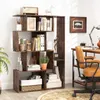 A wooden geometric bookshelf filled with books, plants, and decorative items, placed in a home office setting next to a desk and chair. Náhled obrázku produktu